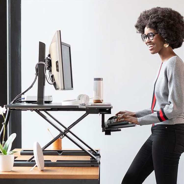 Woman standing at home office standing desk